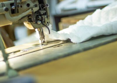 a machine stitching together the part of a custom mattess