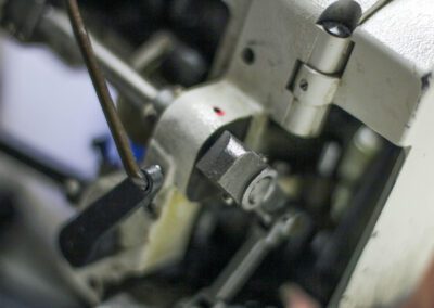 a close up of the stitching machine used to make a custom mattress
