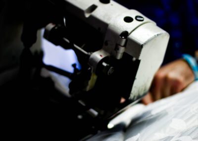 a delakin employee stitching a custom mattress