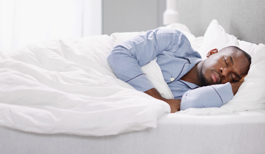 Man sleeping peacefully on a Texas King Mattress by Delarkin.